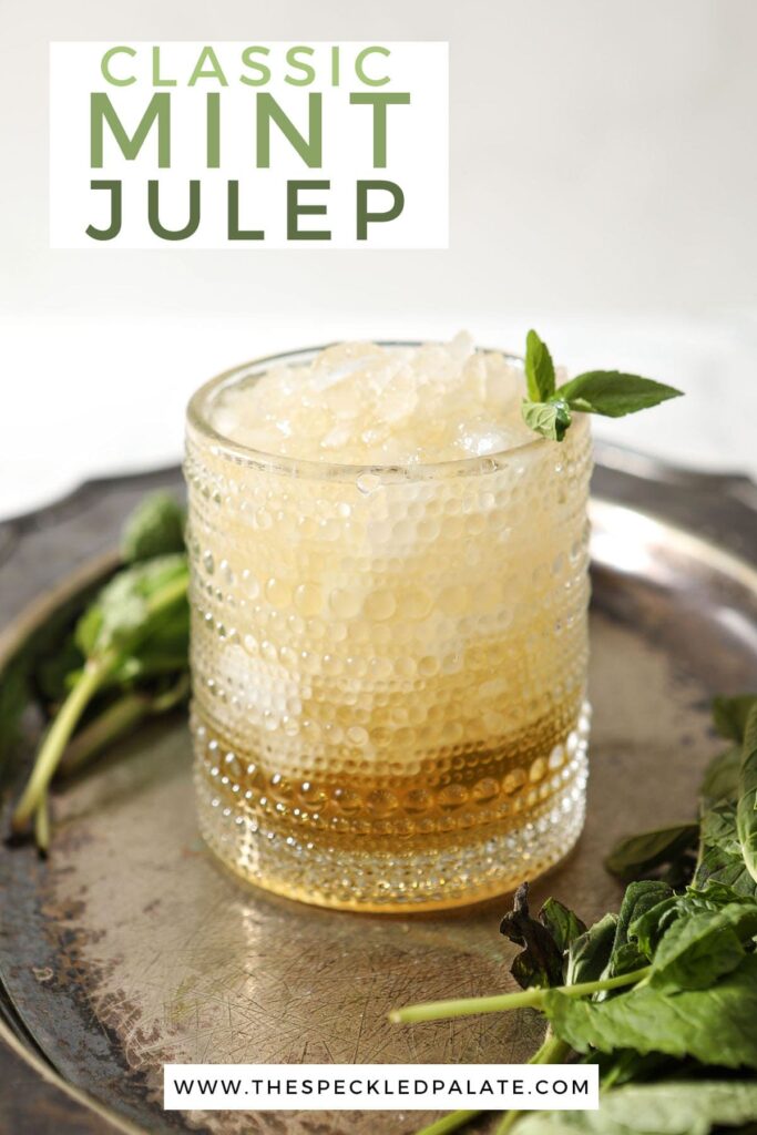 A mint julep with a mint sprig on a silver tray with the text 'classic mint julep'