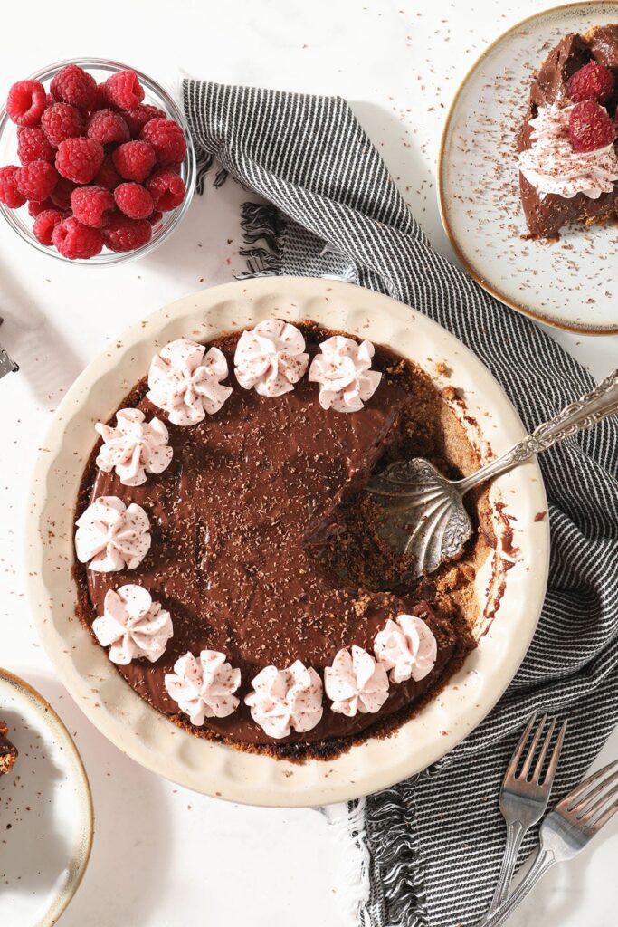 A chocolate pie missing one slice