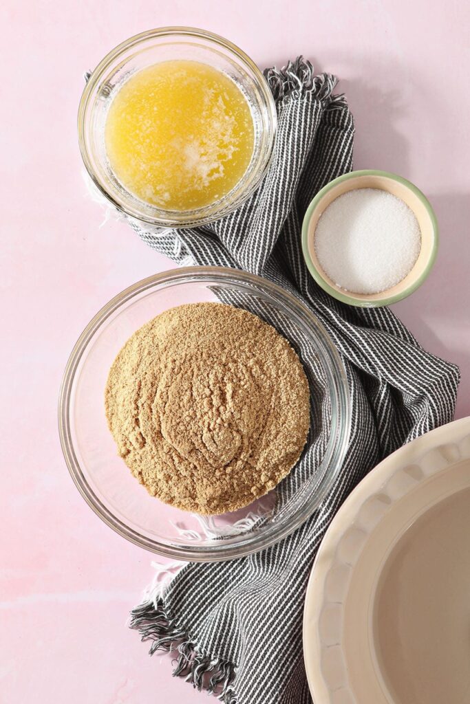 Graham cracker pie crust ingredients in bowls before mixing