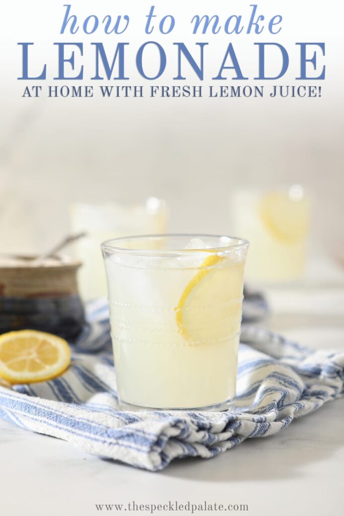 A glass of fresh squeezed lemonade on a blue and white striped towel with Pinterest text