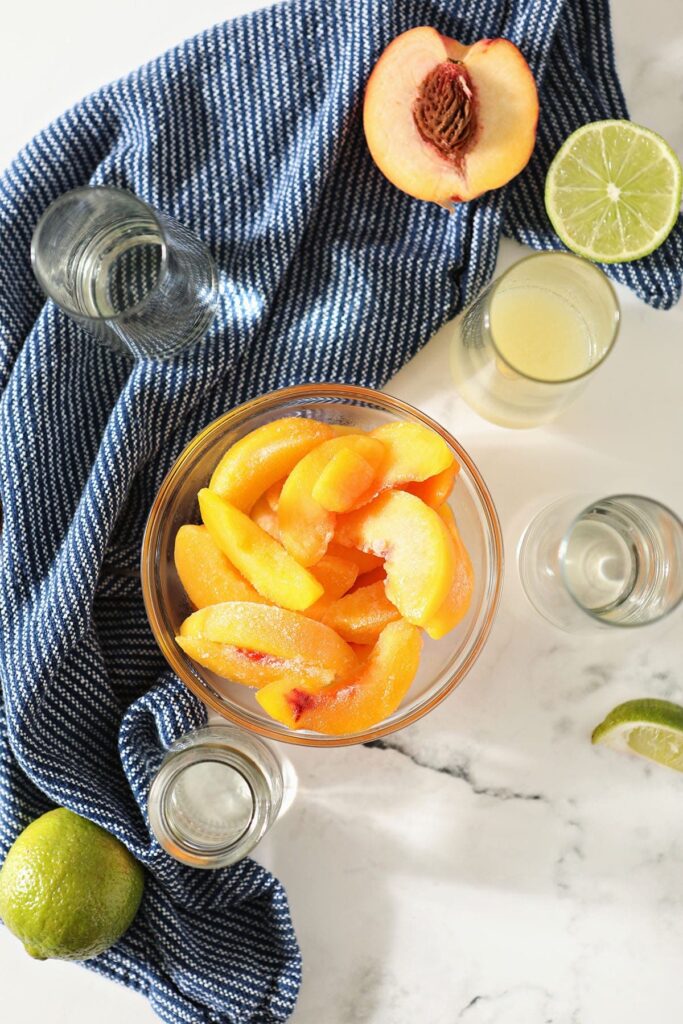 Peaches and other margarita ingredients in bowls