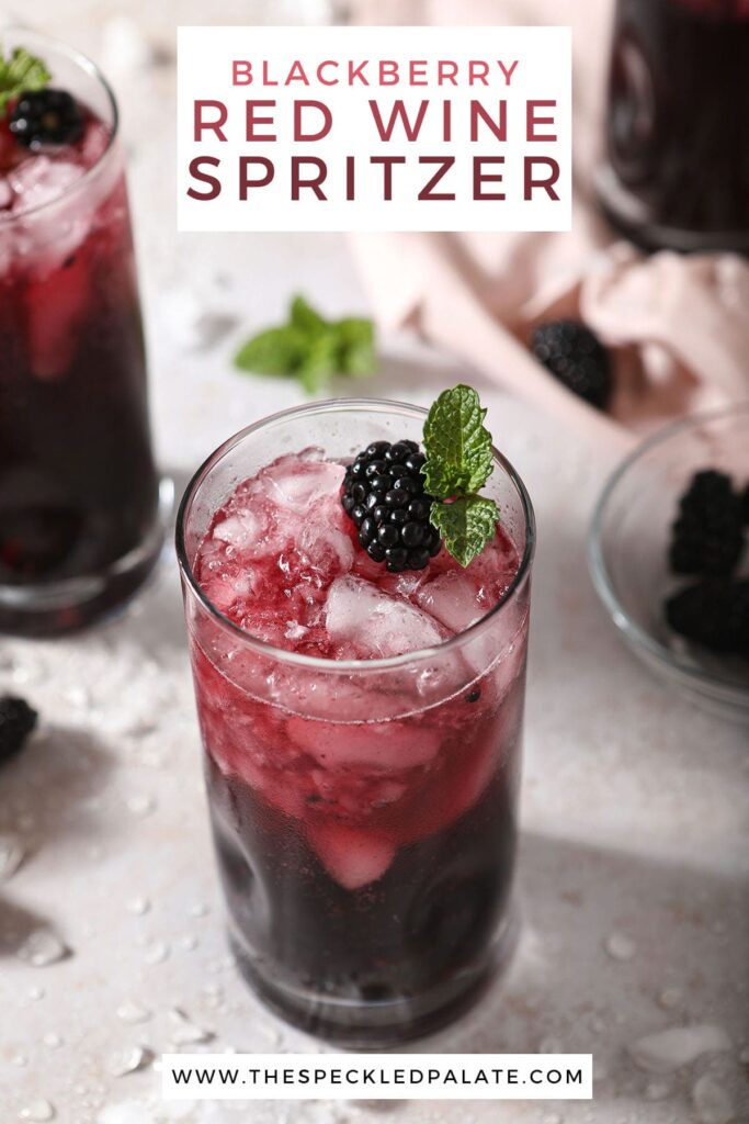 Two spritzers garnished with blackberries and mint with the text blackberry red wine spritzers