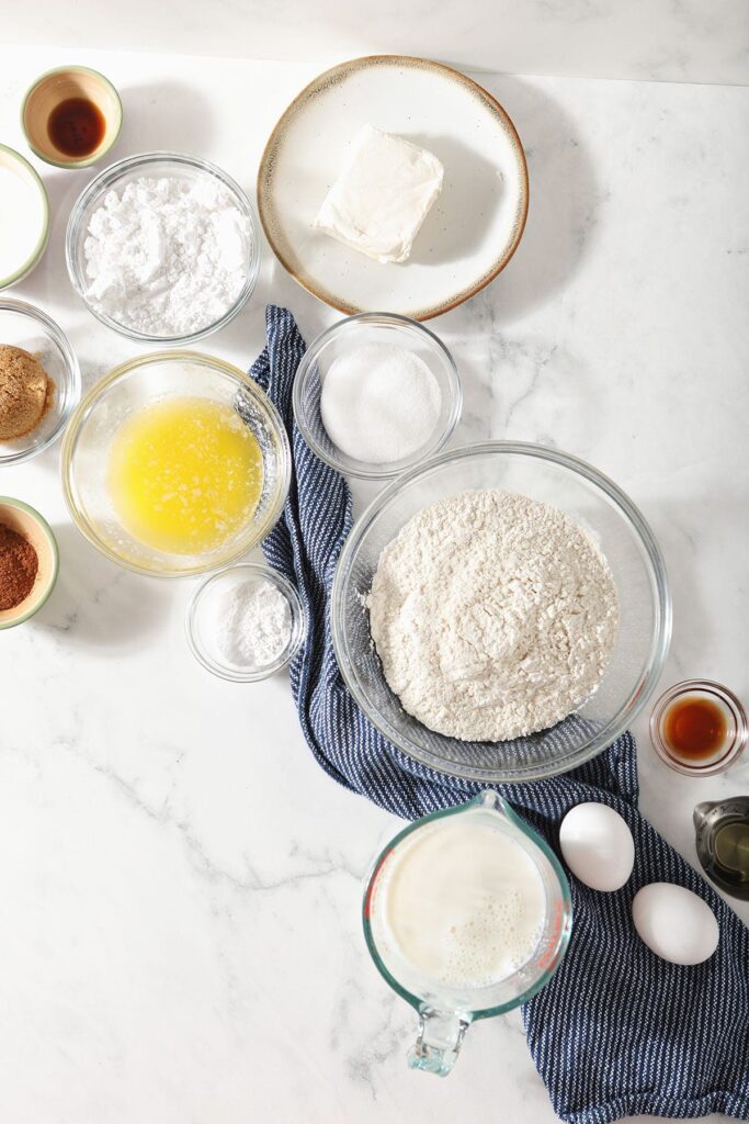 Homemade pancake recipe ingredients in bowls on a marble countertop