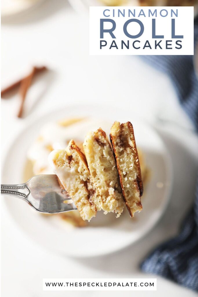 A fork holds a slice of pancakes with the text cinnamon roll pancakes