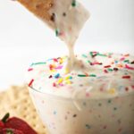A graham cracker dips into Funfetti Dip