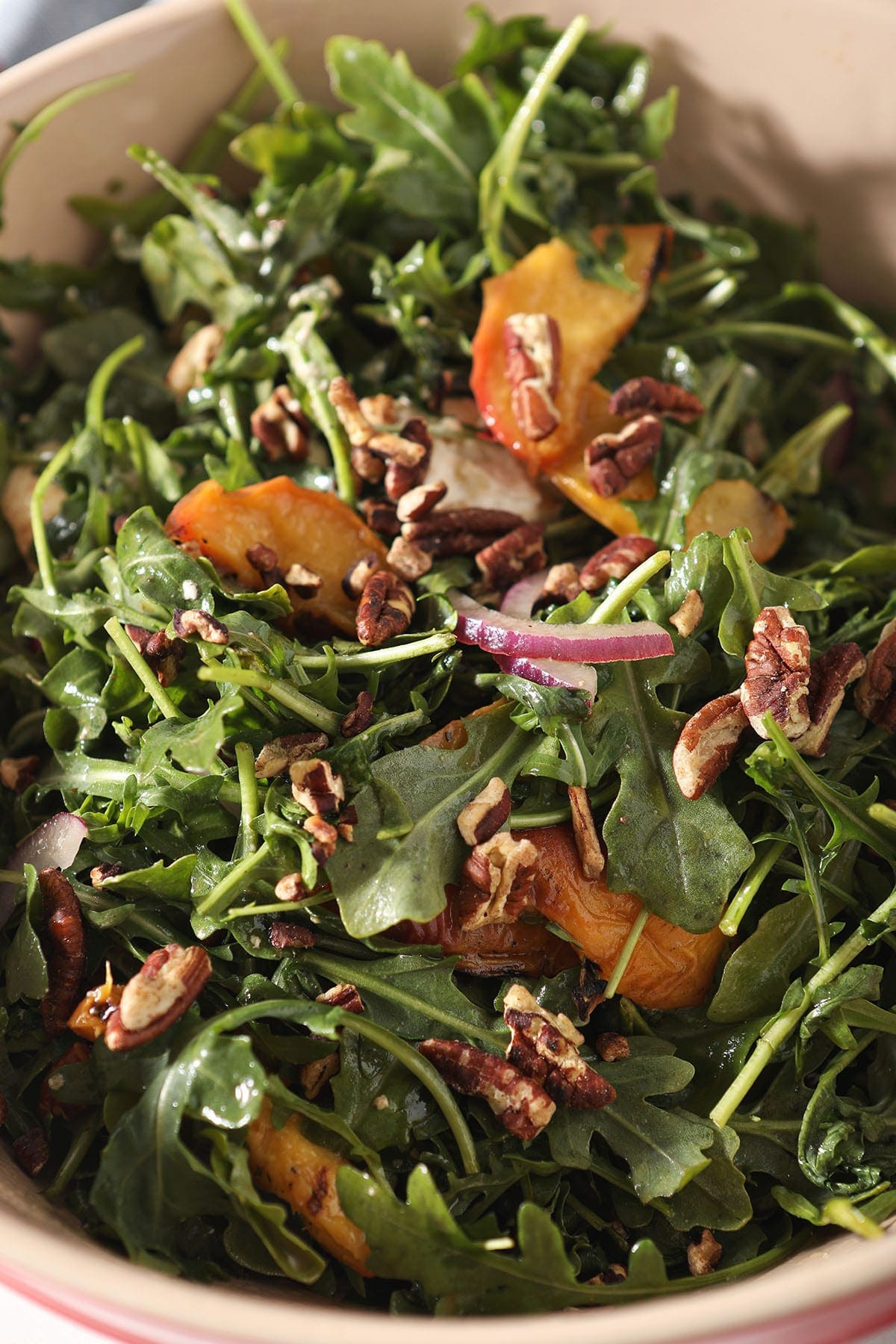 Close up of an arugula salad with peaches