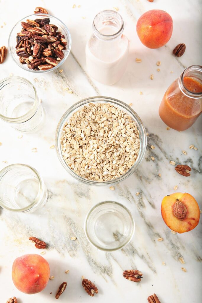 Ingredients to make vegan overnight oats in bowls on marble