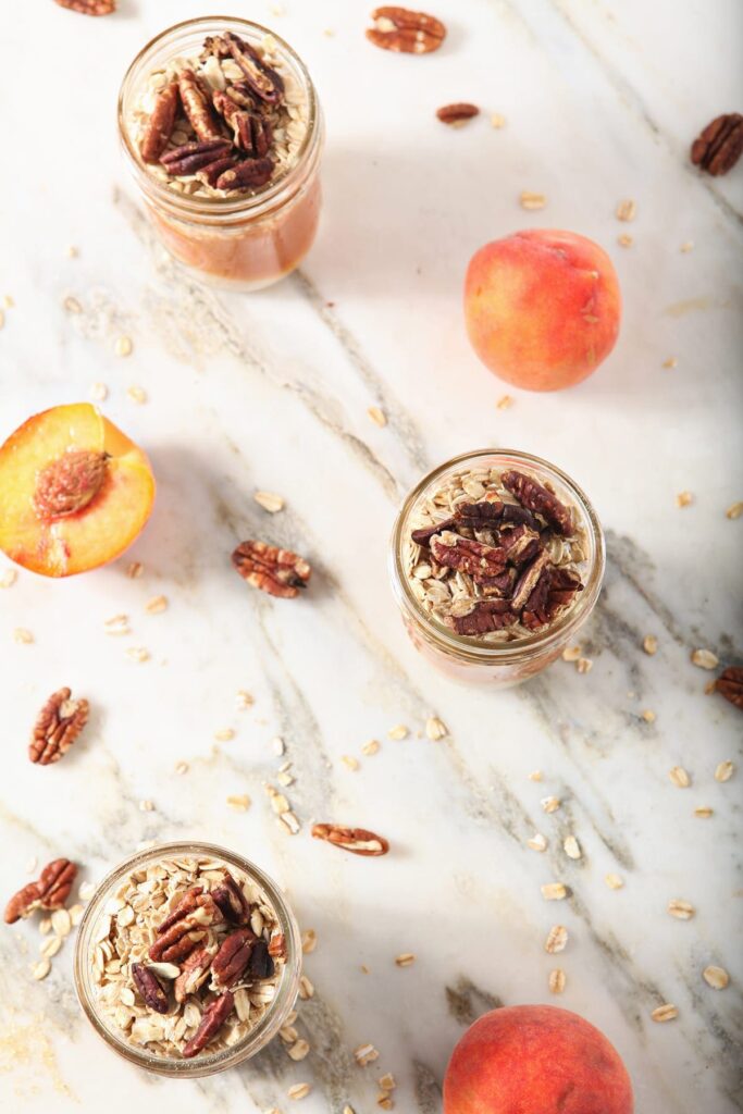 Three jars of Overnight Oats with pecans on marble