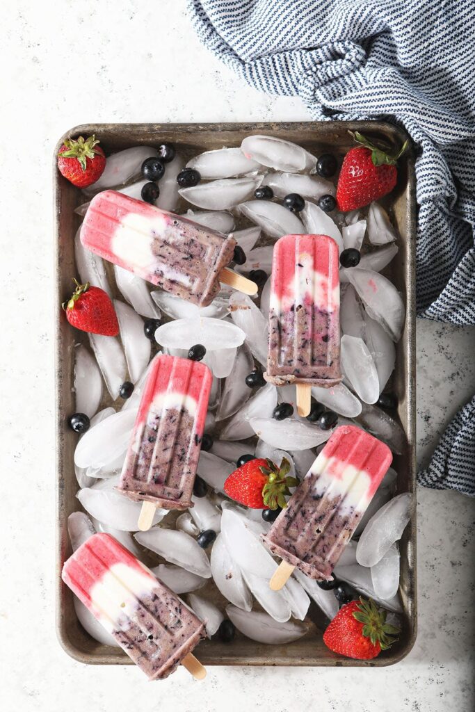 Five patriotic popsicles on an ice-filled tray