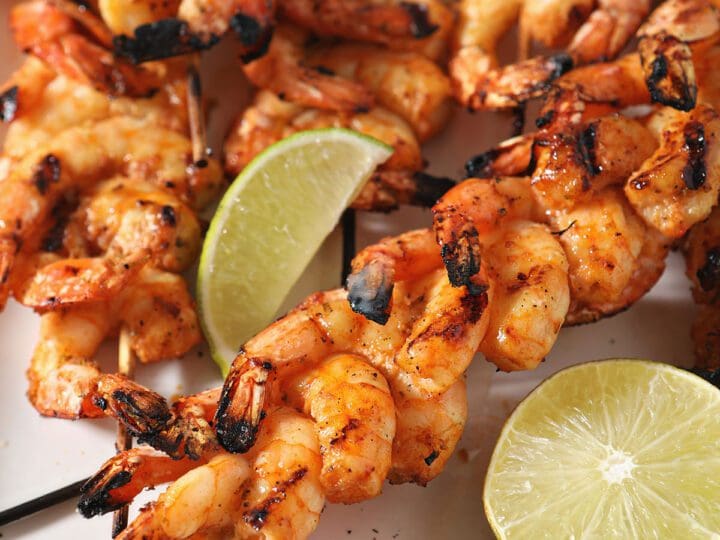 Skewers of shrimp on a white plate