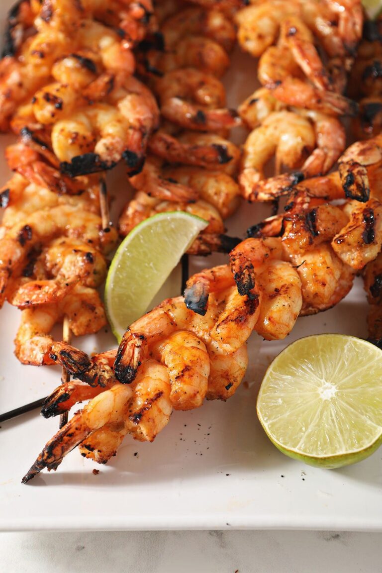 Skewers of shrimp on a white plate