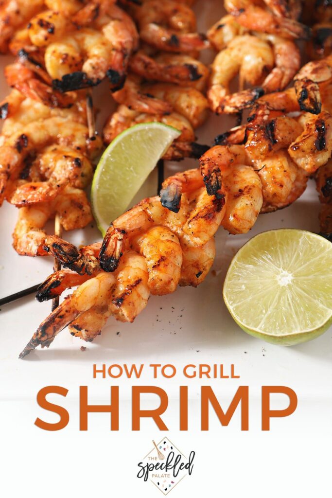 Shrimp skewers with lime wedges on a white plate with the text how to grill shrimp