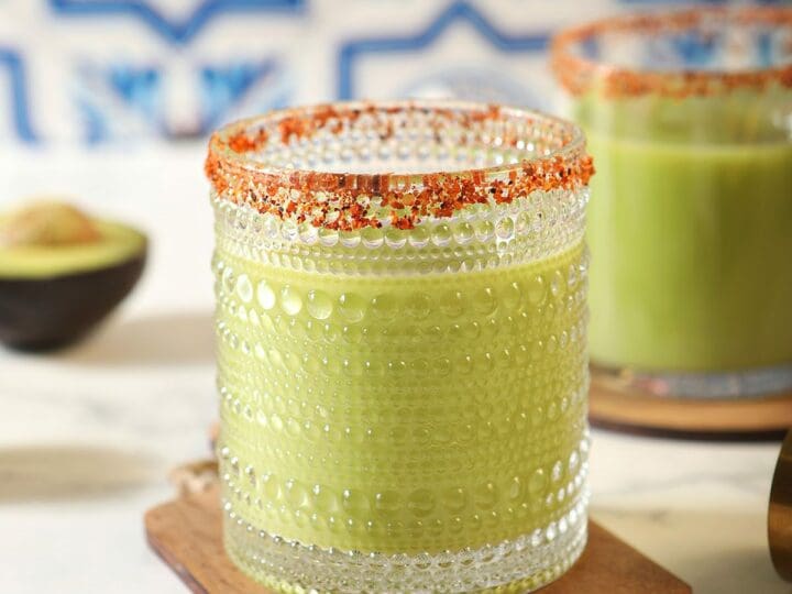 Two Avocado Margaritas on wood coasters