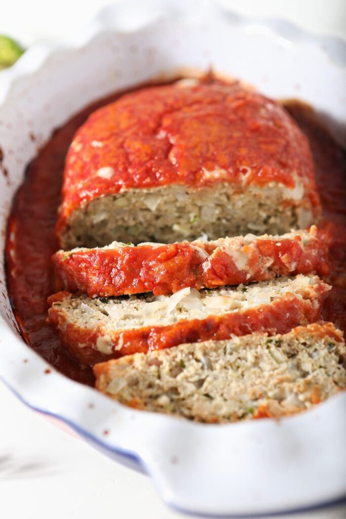 Sliced Italian Chicken Meatloaf in a roasting pan