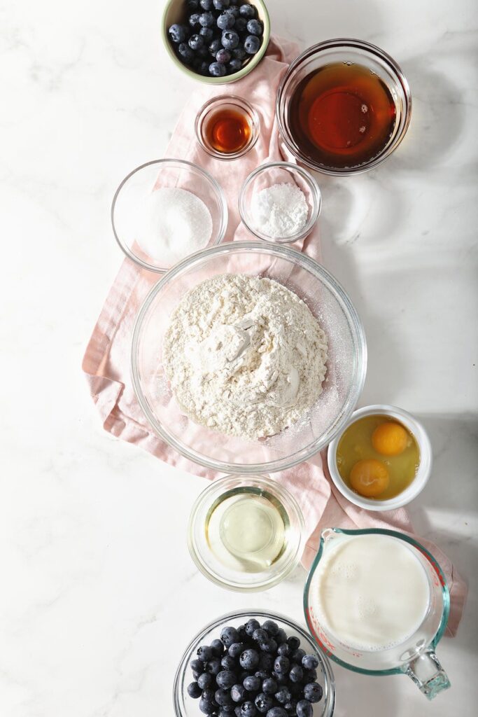 Pancake ingredients in bowls on marble