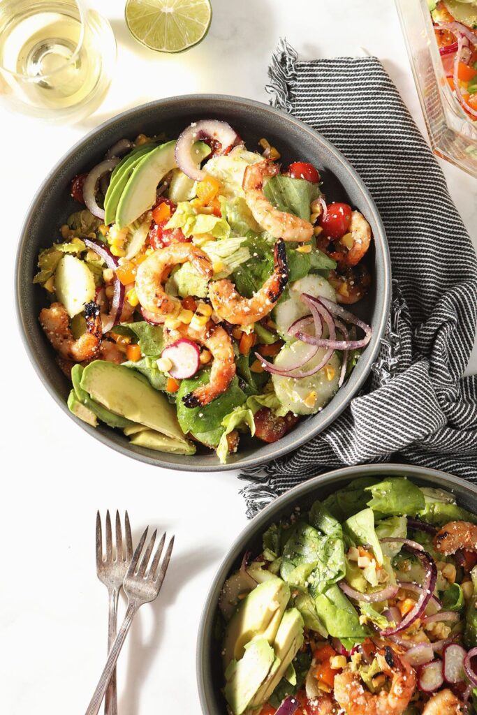 Two bowls of grilled shrimp salad with lime vinaigrette