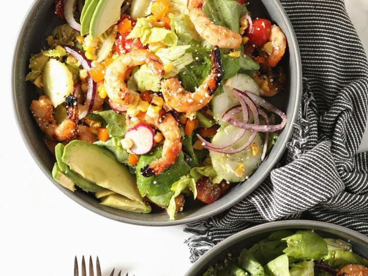 Two bowls of grilled shrimp salad with lime vinaigrette