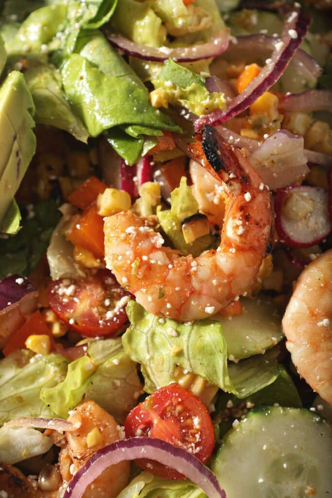 Close up of grilled shrimp on salad