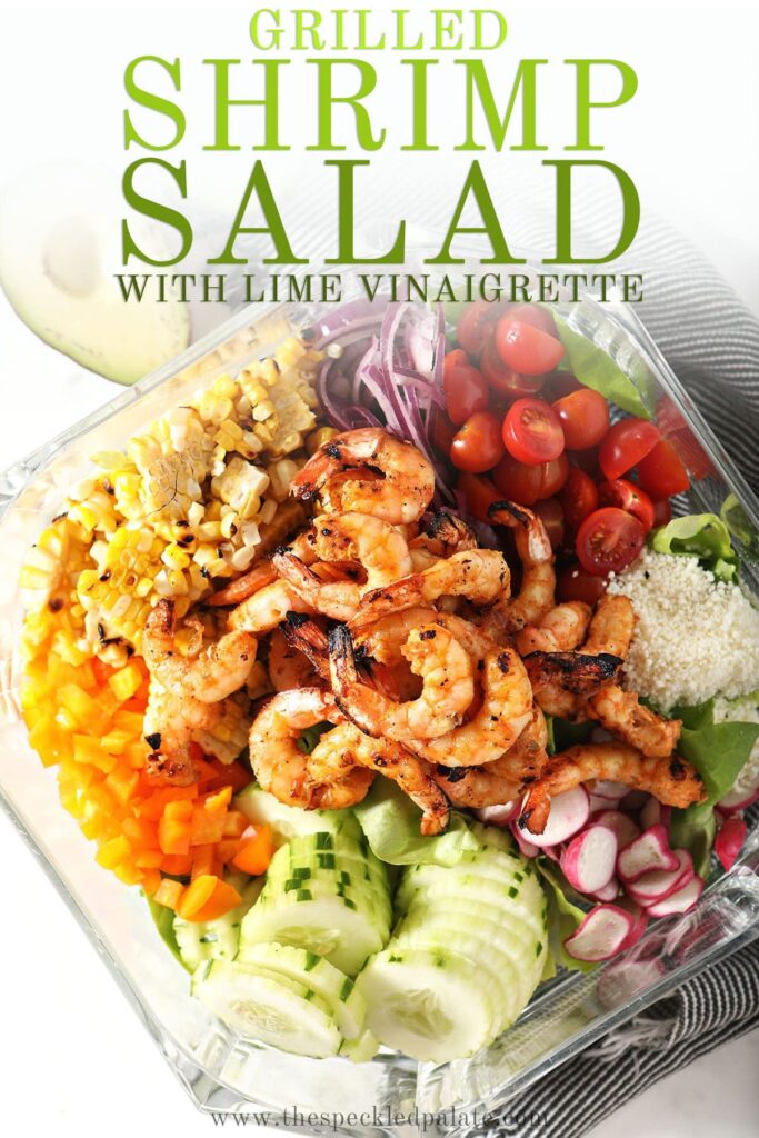 Colorful salad ingredients in a bowl with the text grilled shrimp salad with lime vinaigrette