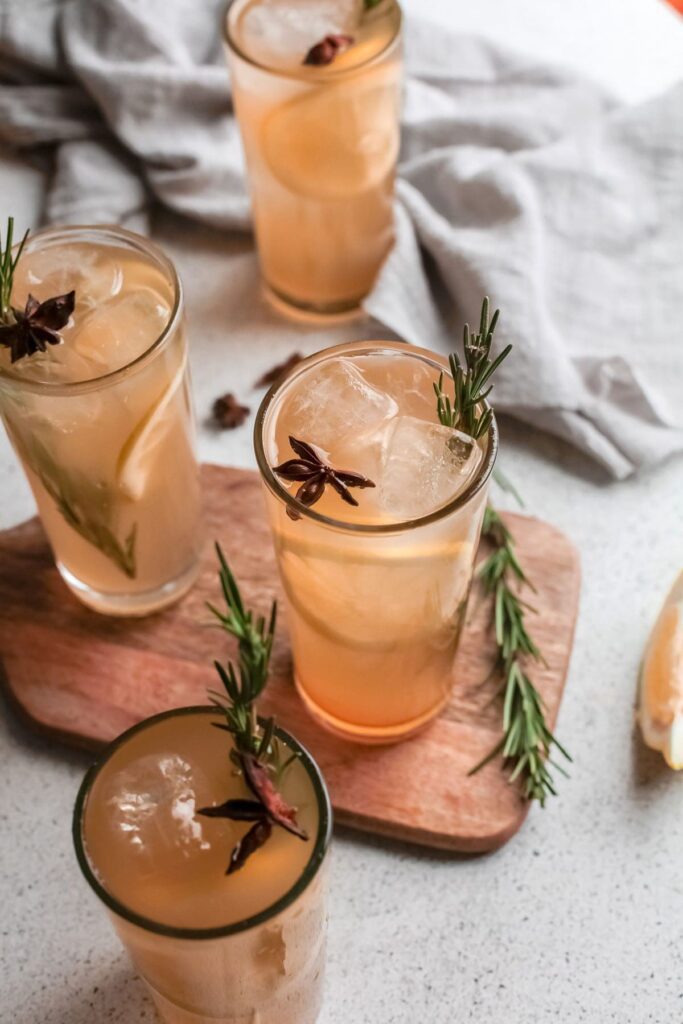 Four Pumpkin Whiskey Smash drinks garnished with rosemary