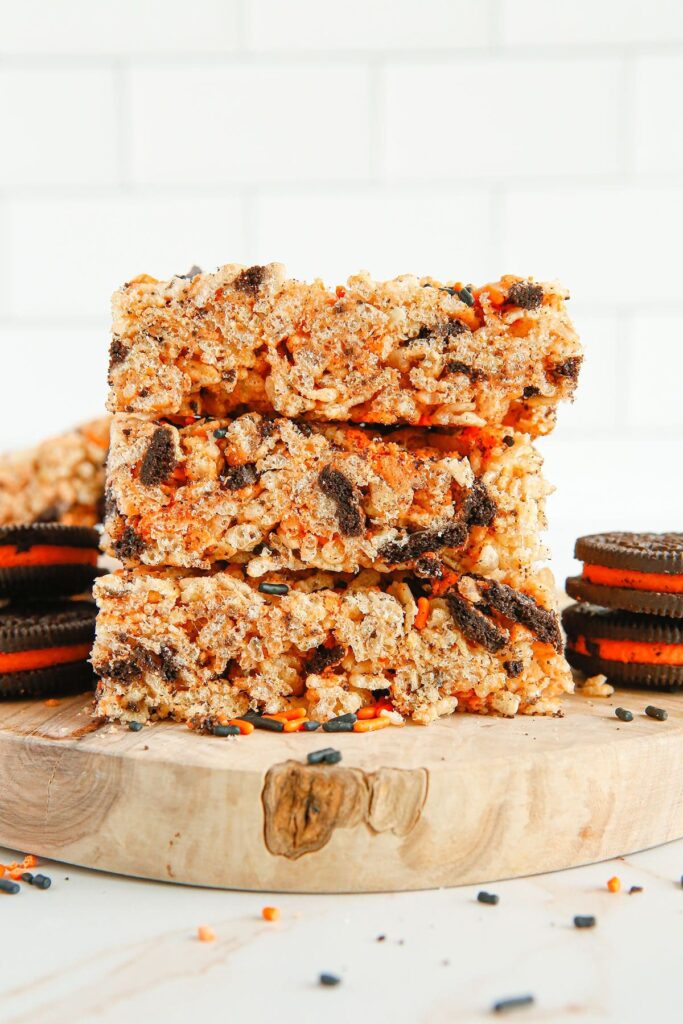 A stack of Halloween Oreo Rice Krispie Treats on wood