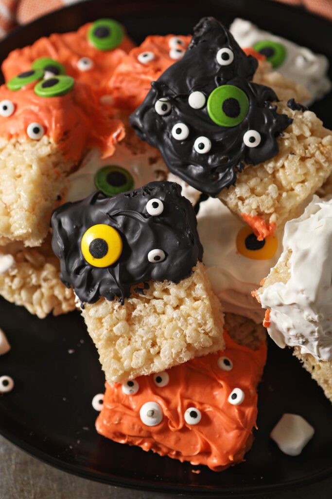 Decorate Monster Halloween Rice Krispie Treats on a black plate