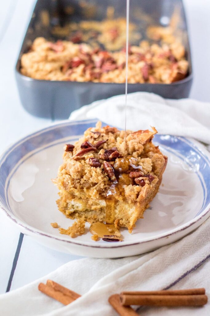 Syrup pours onto a slice of baked French Toast casserole