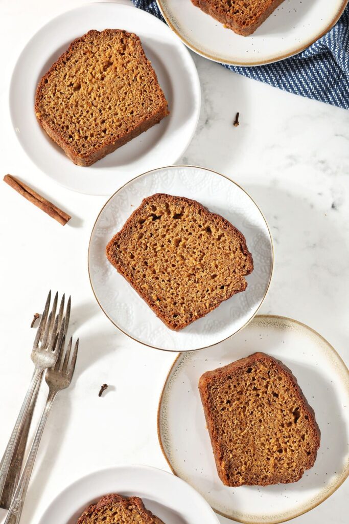 Slices of pumpkin bread on white plates