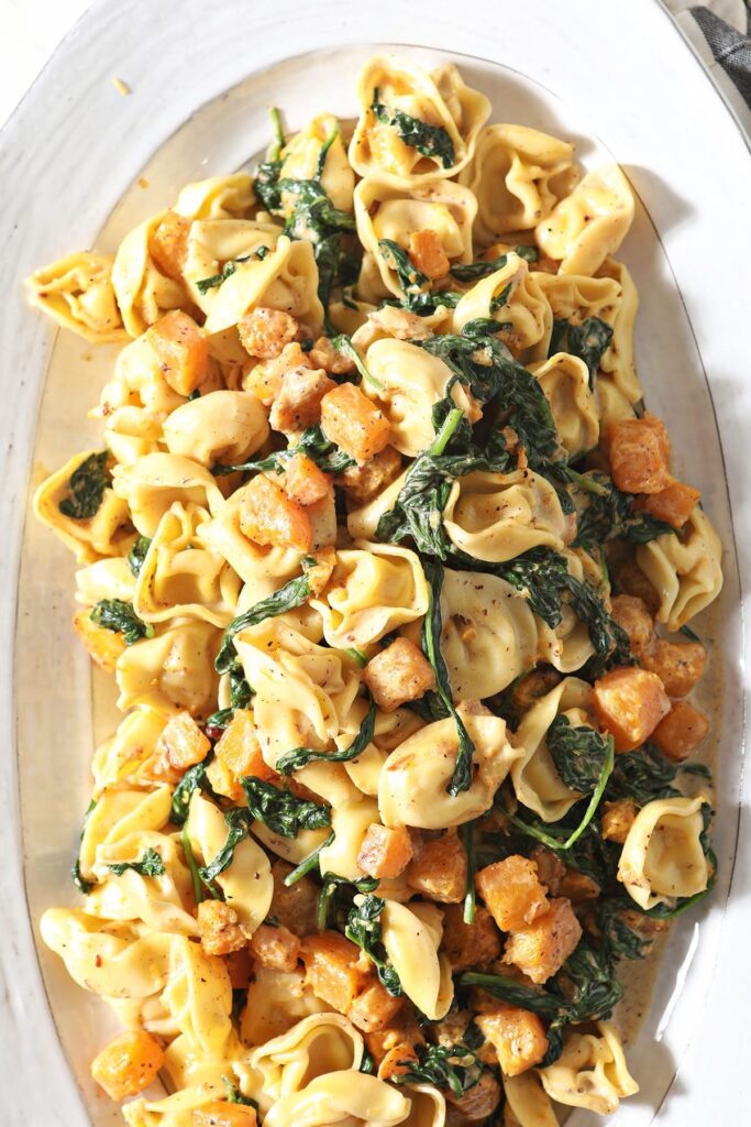 Tortellini Butternut Squash Pasta with Pancetta and Spinach on a large white serving platter