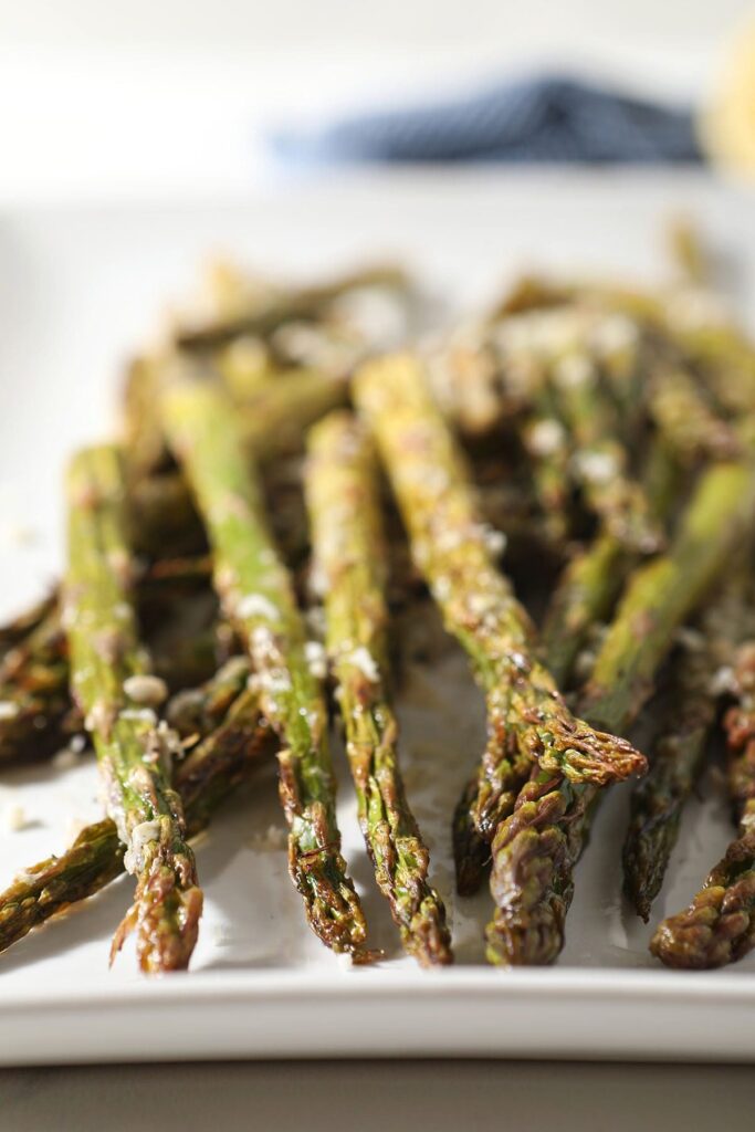 Broiled asparagus on a white plate