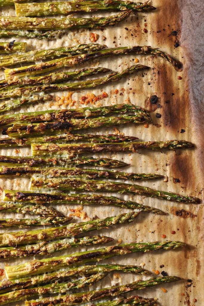 Broiled Asparagus with Lemon and Parmesan on a baking sheet