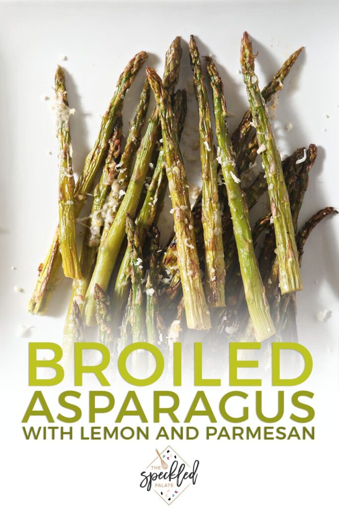 Asparagus spears on a white plate with the text broiled asparagus with lemon and parmesan