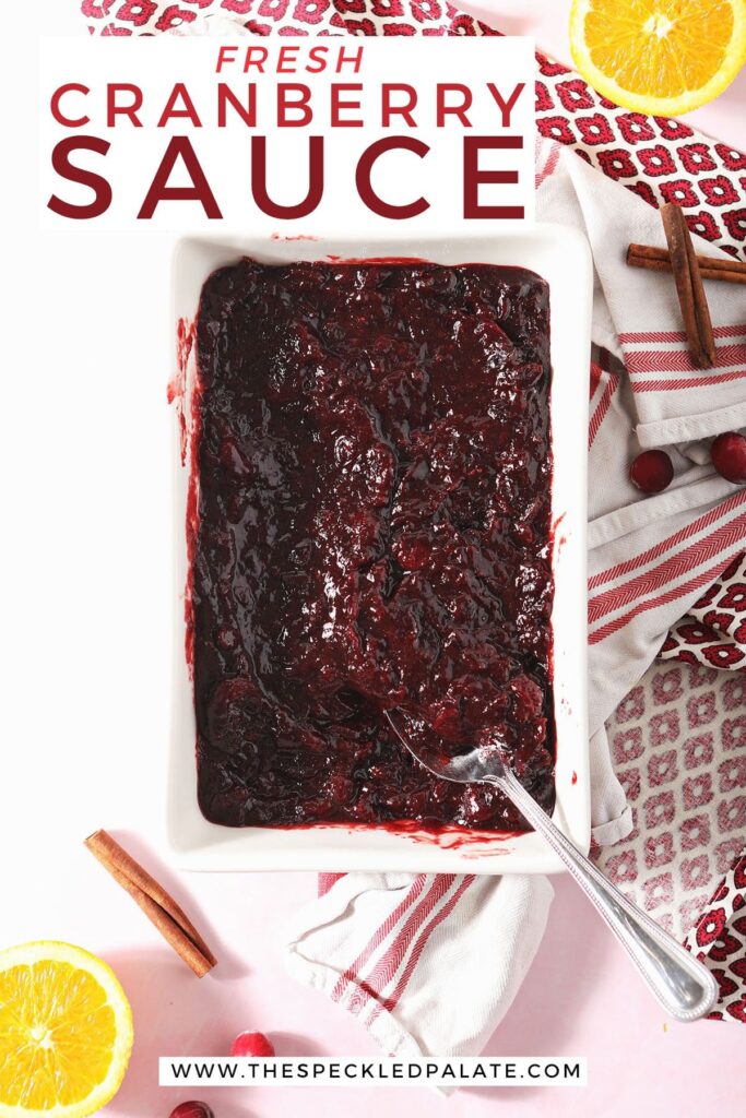 A spoon sits in a casserole of cranberry sauce with the text fresh cranberry sauce