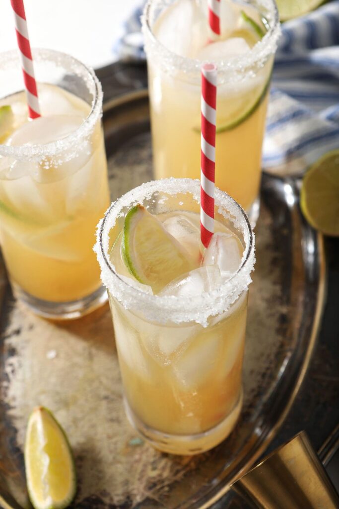 Close up of a golden italian margarita with a lime garnish