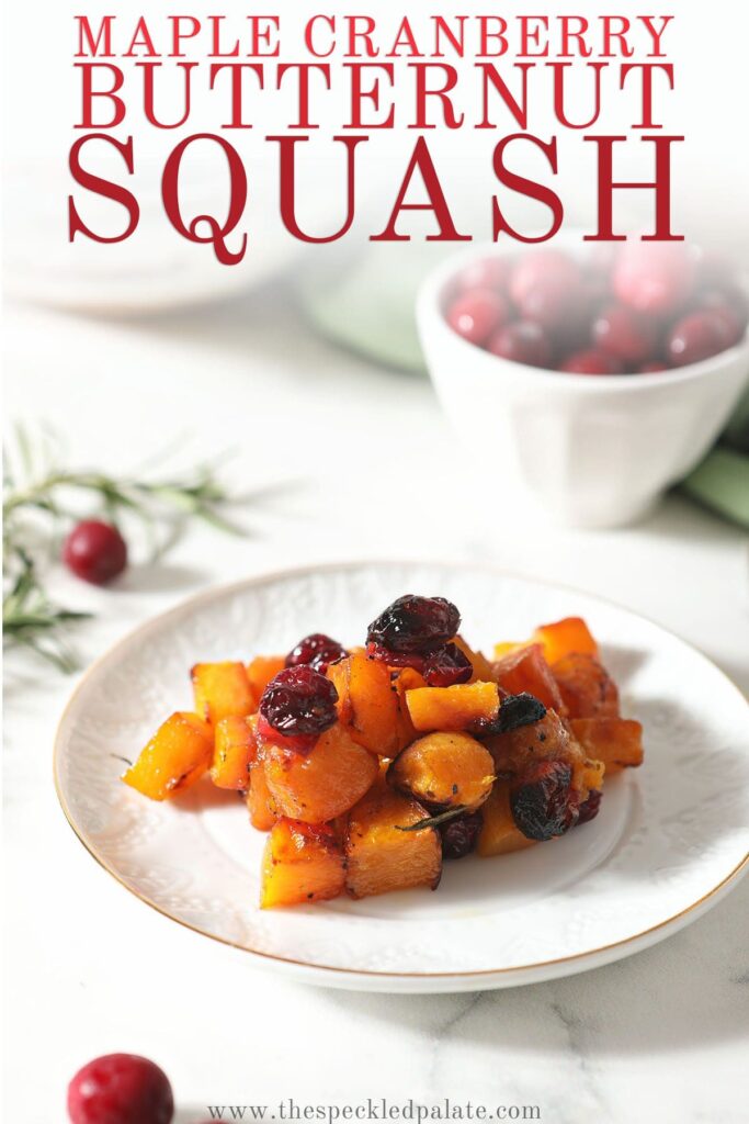 A white plate holds a serving of butternut squash with the text maple cranberry butternut squash