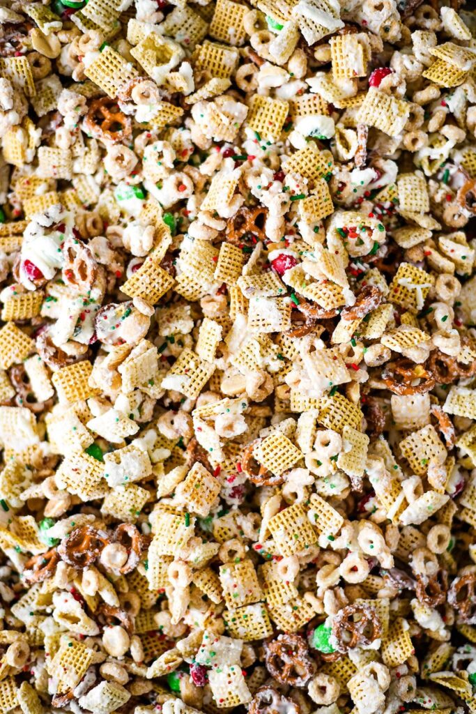 Close up of tossed Christmas Chex Mix on a pan