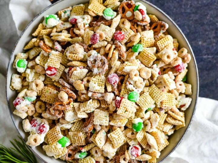 A bowl of Christmas Chex Mix with holly