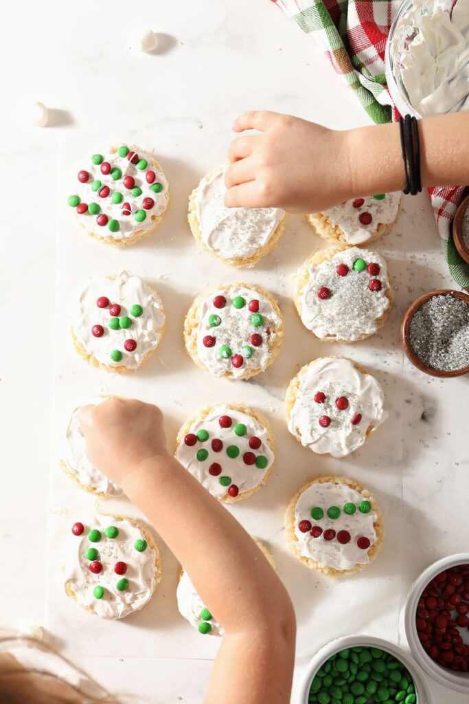 Two kids decorate Christmas Rice Krispie Treats