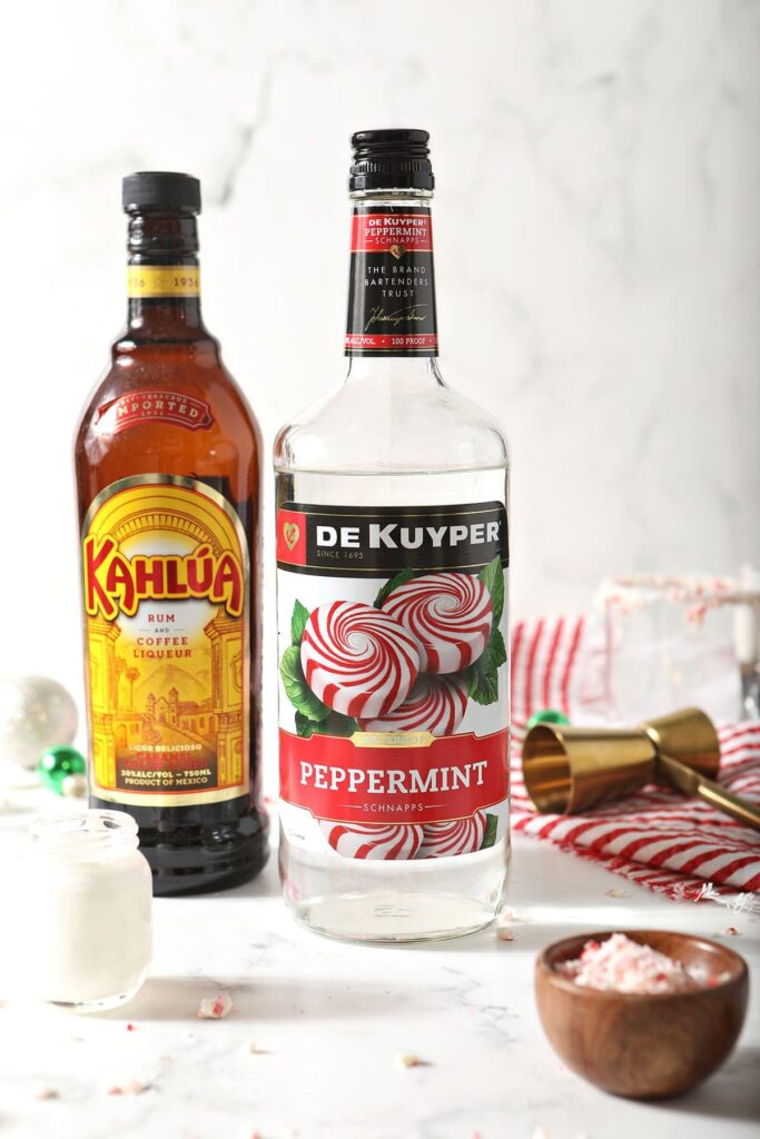 Peppermint schnapps, Kahlua and cream in bottles on marble