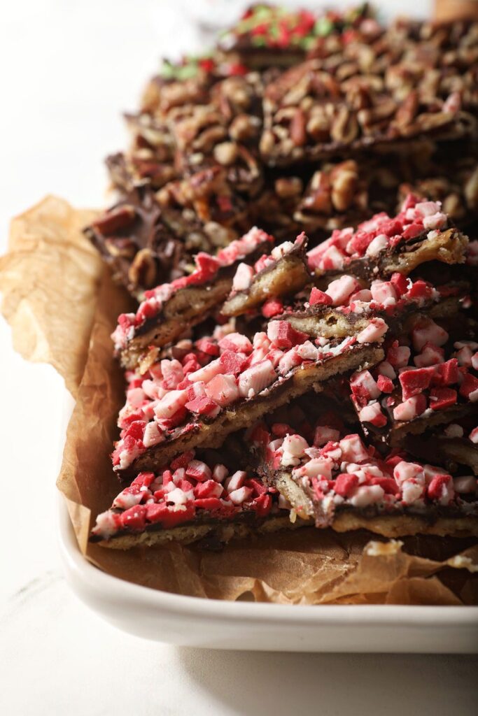 A plate of Christmas Cracker Toffee with peppermint and nuts