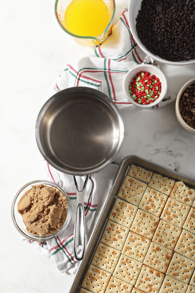 Ingredients to make saltine cracker toffee on marble