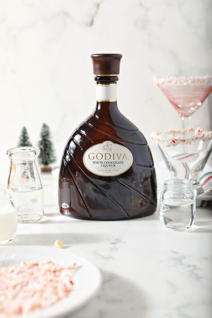 A bottle of Godiva white chocolate liqueur with other bottled drink ingredients