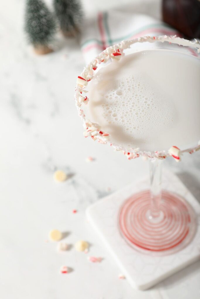 Close up of a martini rimmed in candy canes