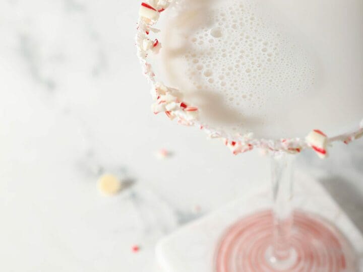 Close up of a martini rimmed in candy canes