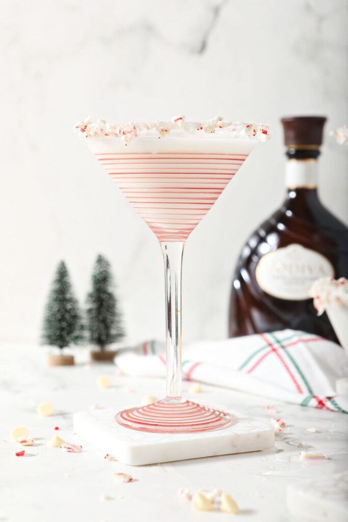 A white christmas martini on a marble coaster