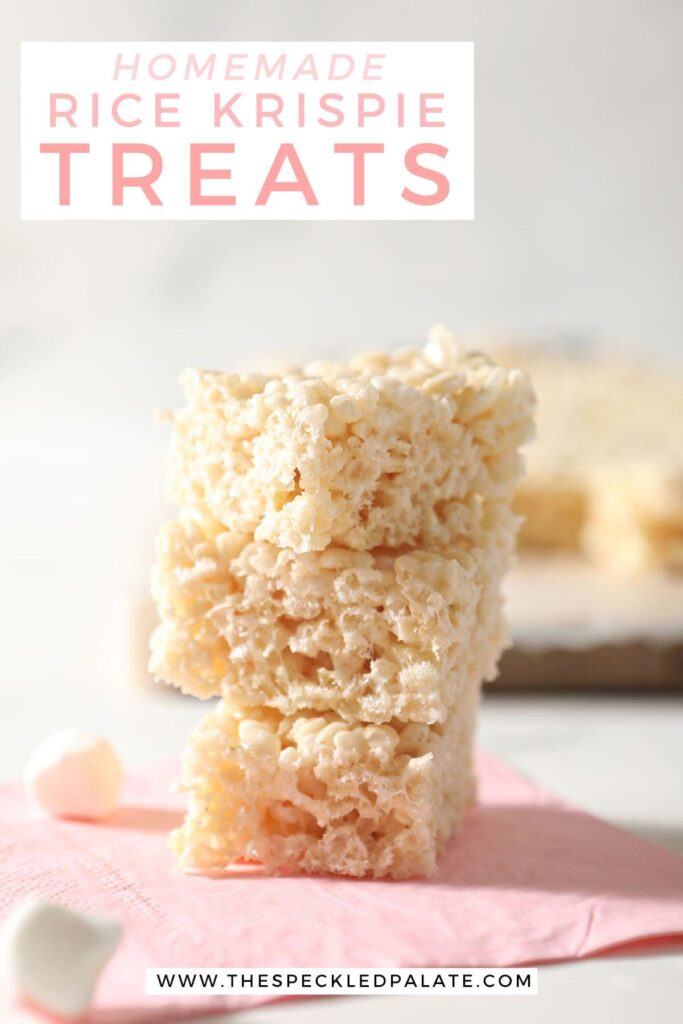 A stack of three crispy rice treats on a pink napkin with the text homemade rice krispie treats