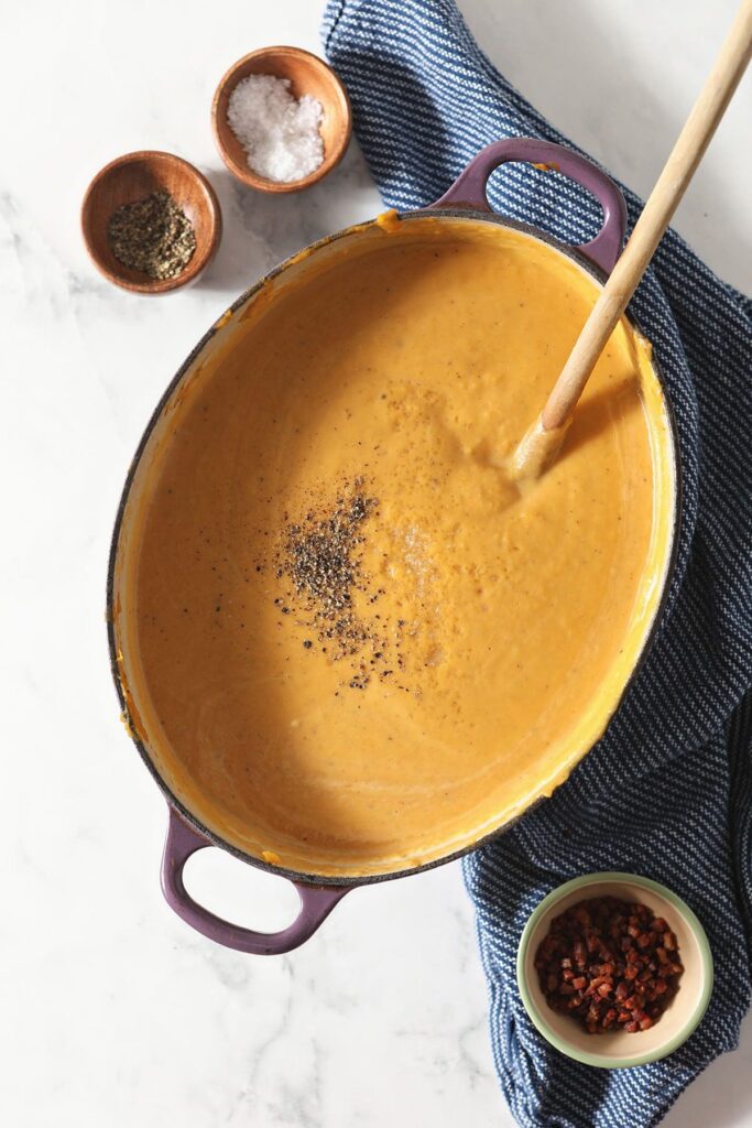 A Dutch oven full of creamy butternut squash soup