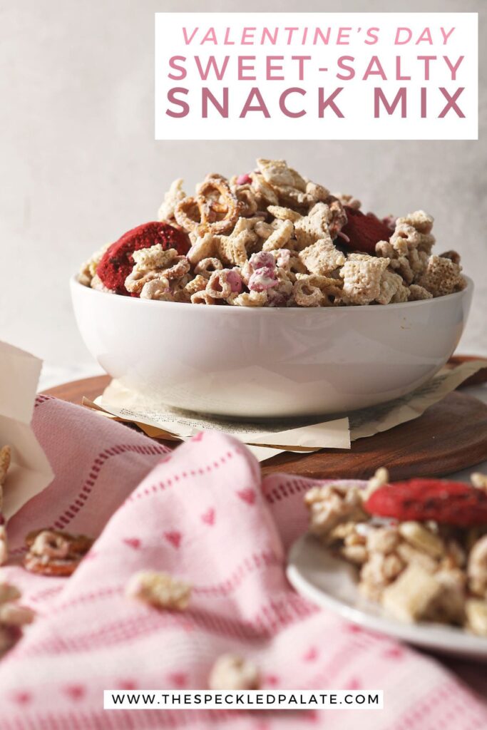 A bowl of pink and red Chex mix with the text Valentine's Day sweet-salty snack mix