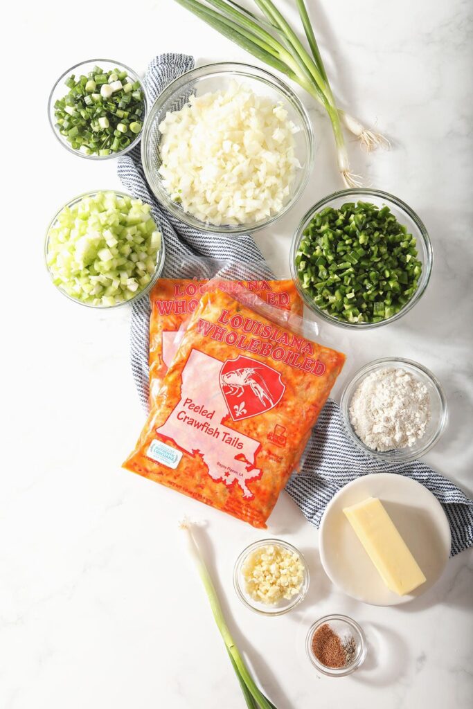 Ingredients to make crawfish pie filling on a blue towel