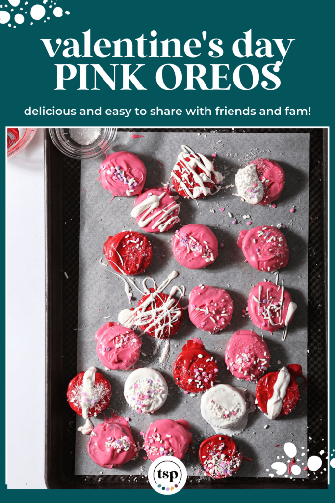 A sheet pan holding pink, red and white decorated chocolate-dipped Oreos with the text Valentine's Day Pink Oreos delicious and easy to share with friends and fam